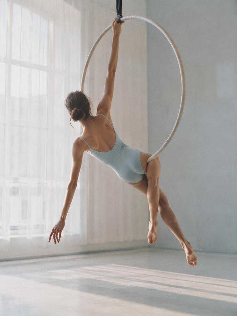 Generated illustrative placeholder: Anonymous performer on an aerial hoop in a bright studio