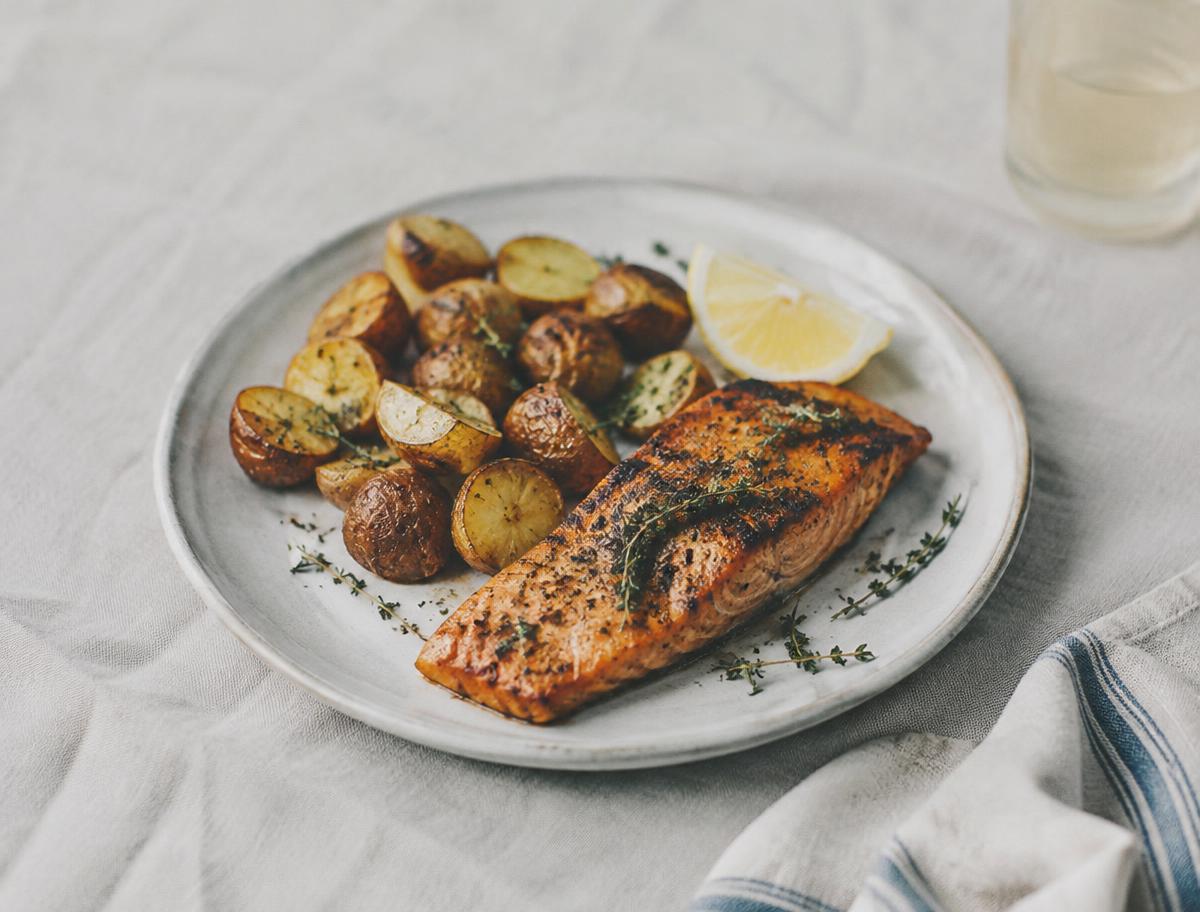 Generated illustrative placeholder: Roasted potatoes and seared salmon with lemon and thyme